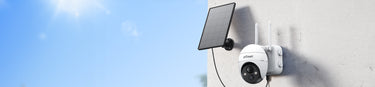 ieGeek white security camera with solar panel ZS-GX1S on a wall against a blue sky
