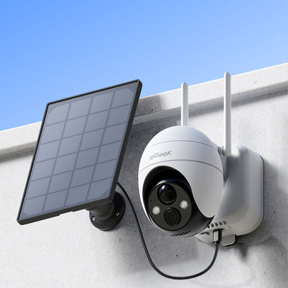 ieGeek outdoor battery security camera with solar panel on a wall against a blue sky